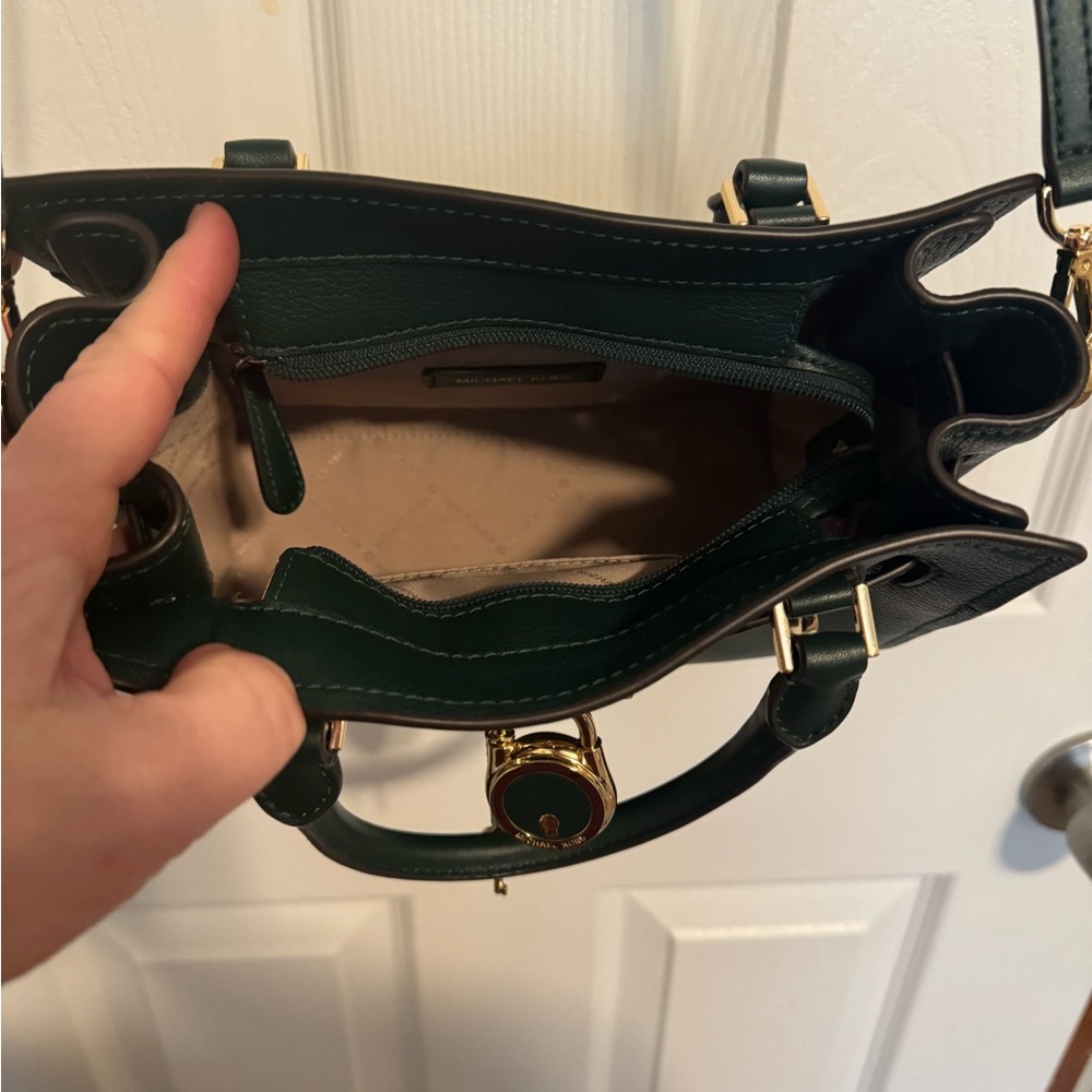 This is a Michael Kors dark green crossbody